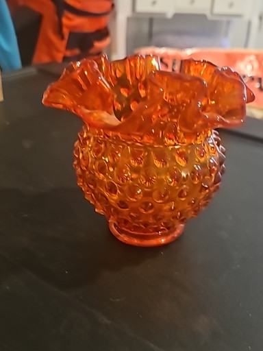 Orange amberina glass hobnail vase with ruffled rim by Fenton