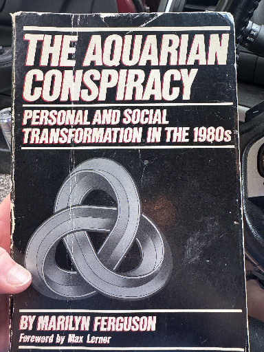 Softcover book titled 'The Aquarian Conspiracy: Personal and Social Transformation in the 1980s' by Marilyn Ferguson