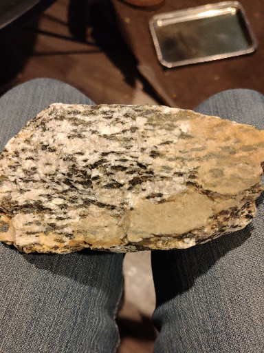 Granite pegmatite rock specimen with mica, feldspar, and quartz inclusions