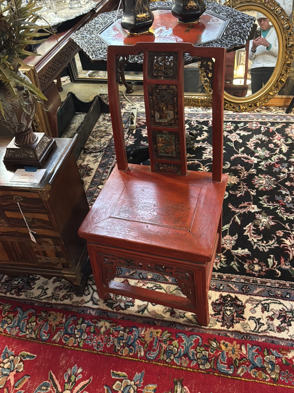 Chinese red lacquered wood chair with carved and gilt decorative panels