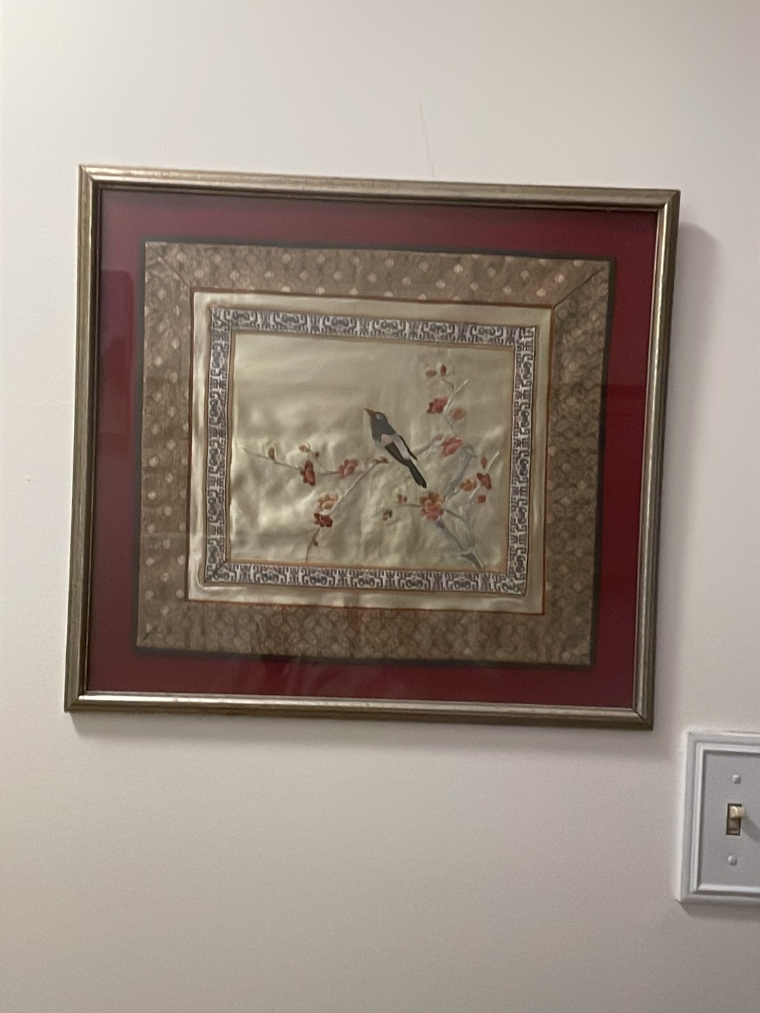 Chinese silk embroidery depicting a bird on a flowering branch