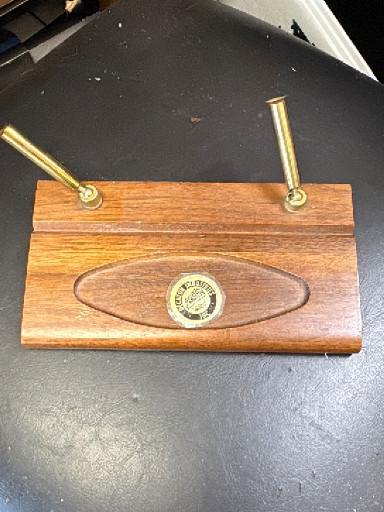 Wooden desk pen holder with brass posts and commemorative medallion