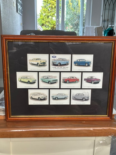 Framed set of vintage Ford cigarette cards depicting 1950s–1960s Ford models