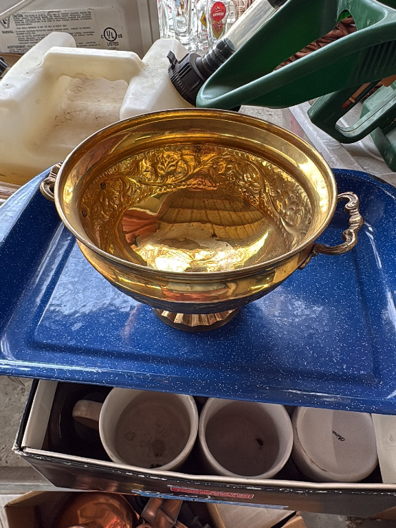 Brass footed bowl with decorative handles and embossed floral design