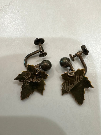 Pair of vintage screw-back earrings with leaf-shaped dangles marked 'Alaska'