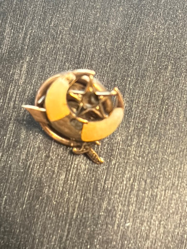 Gold fraternal pin with crescent moon and star design, likely Shriners or similar organization