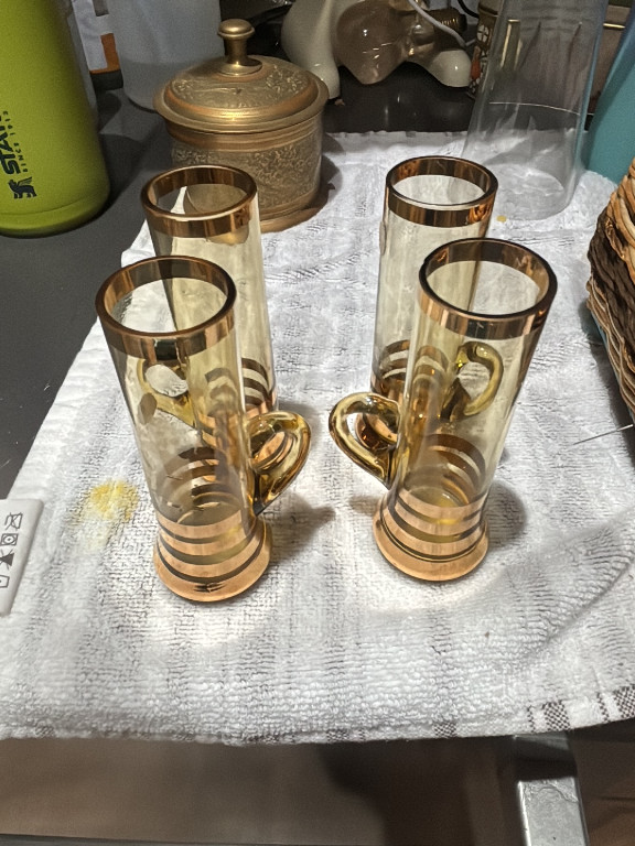Set of four vintage glass cordial or tea glasses with gold-tone striped decoration and applied handles