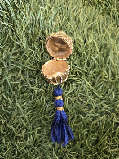Vintage Estee Lauder solid perfume locket pendant with blue tassel