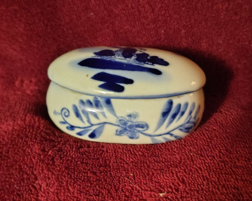 Delft-style blue and white ceramic trinket box with windmill and floral motifs