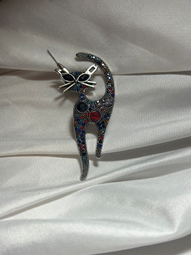 Metal cat brooch with marcasite and colored crystal embellishments