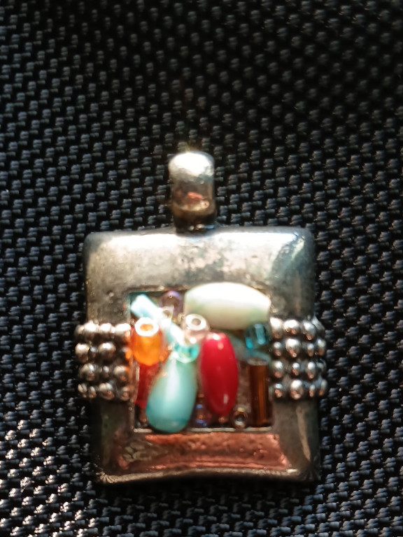 Sterling silver pendant with multi-stone inlay including turquoise, coral, and mother-of-pearl