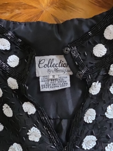 Vintage beaded evening jacket titled 'Collection by Monique' with white floral rosettes and black beadwork