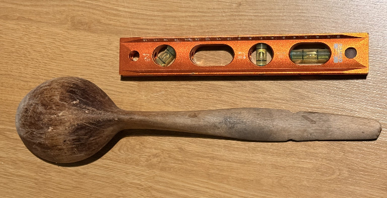 Wooden carved spoon with round bowl and straight handle
