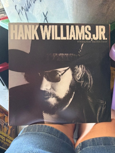 Vinyl LP album 'Whiskey Bent and Hell Bound' by Hank Williams Jr., appears to be autographed