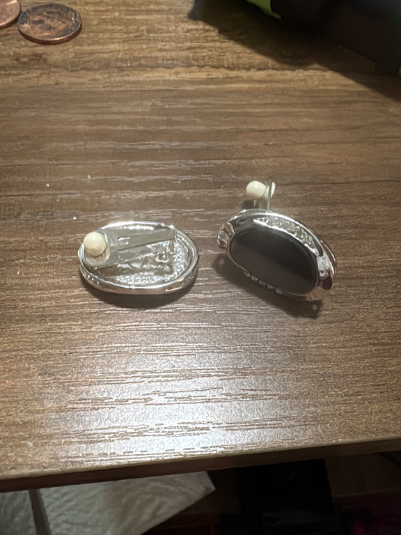 Silver-tone clip-on earrings with dark oval cabochon
