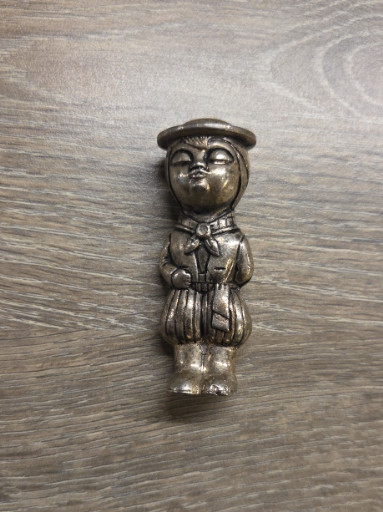 Silver-plated figural spoon featuring a child character in a beret and uniform