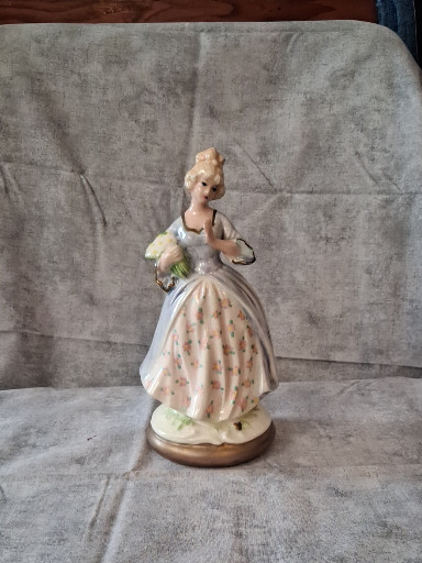 Porcelain figurine of a Victorian lady in a pink dress, made in Japan