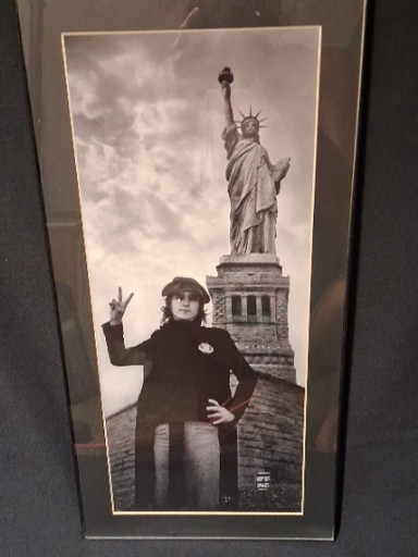 Black and white photograph titled 'John Lennon, Statue of Liberty' by Bob Gruen