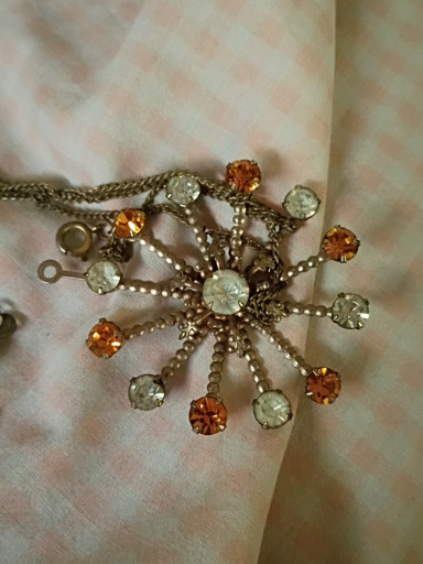 Vintage starburst brooch with yellow and brown rhinestones, circa 1970s