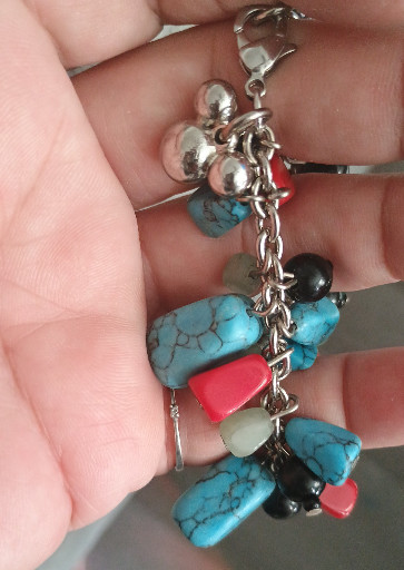 Sterling silver charm bracelet with turquoise, coral, and black onyx beads