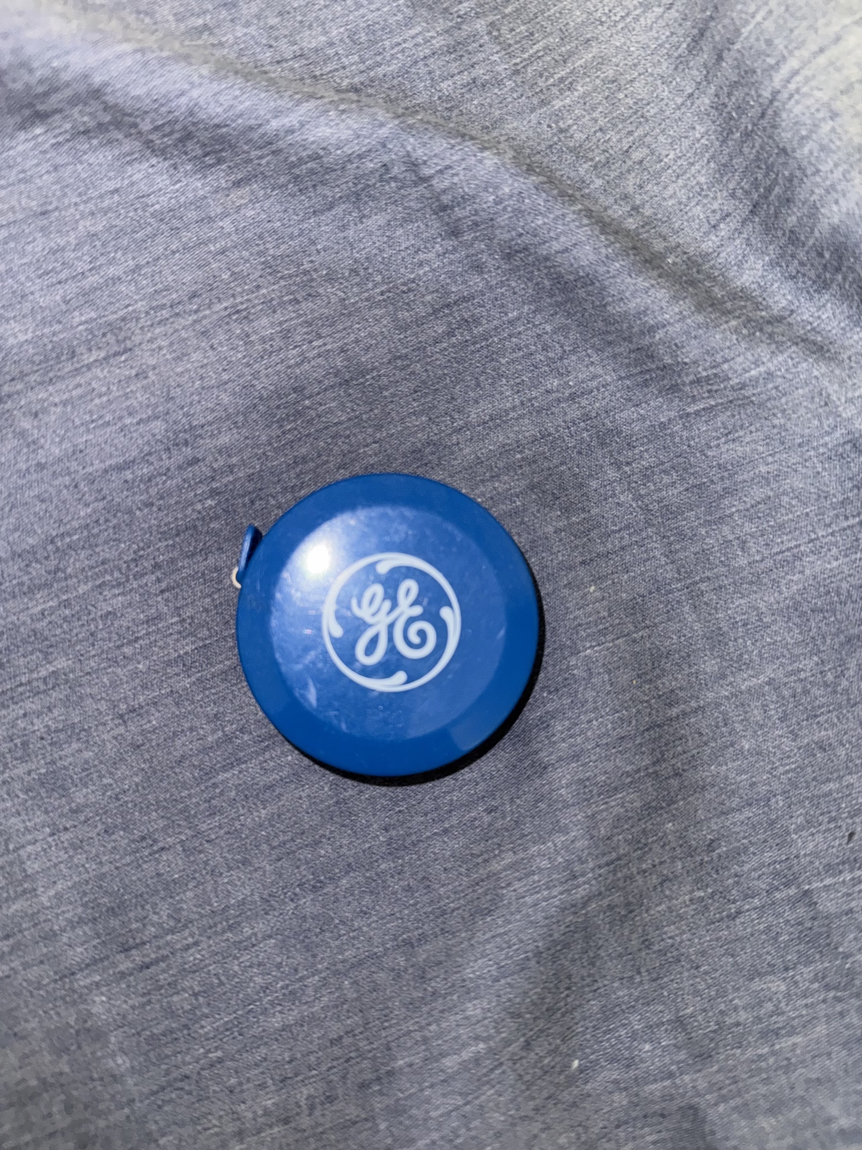 Plastic promotional tape measure with General Electric (GE) logo