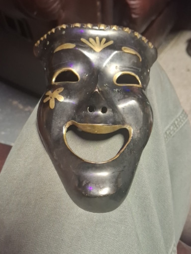 Brass theatrical mask wall decor depicting Comedy face with gold-painted accents