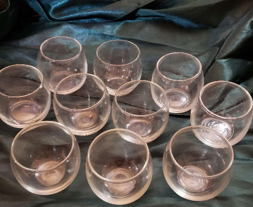 Set of 10 clear glass stemless tumblers, likely reusable promotional glassware from Trappist monastery jams or jellies