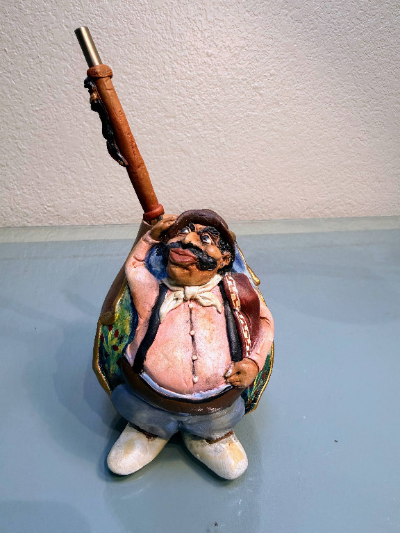 Hand-painted ceramic figurine of a rotund hunter or sportsman with rifle