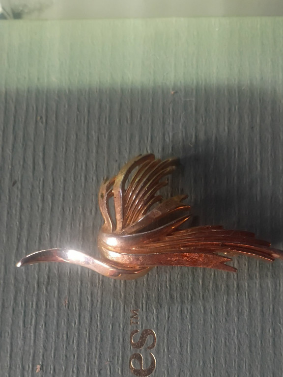 Gold-tone metal brooch in swirl design by Trifari