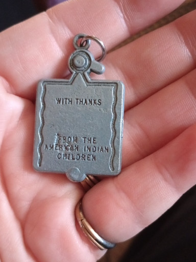 Pewter keychain charm inscribed 'With Thanks From The American Indian Children' with Thunderbird motif