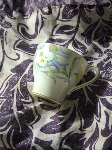 Bone china teacup and saucer with hand-painted floral design by Bell China, England