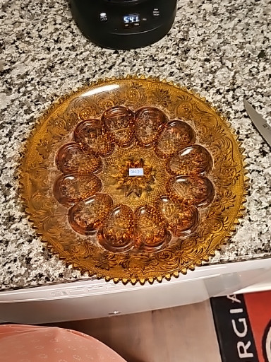Amber pressed glass cake plate or serving platter with daisy and button pattern