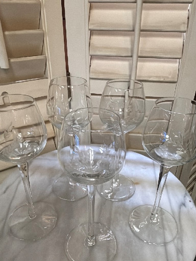 Set of beautiful etched crystal wine glasses with floral pattern. 8” tall x 3” wide.