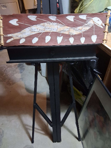 Bark painting depicting a bird (likely a heron or crane) surrounded by leaves, traditional Indigenous Australian art