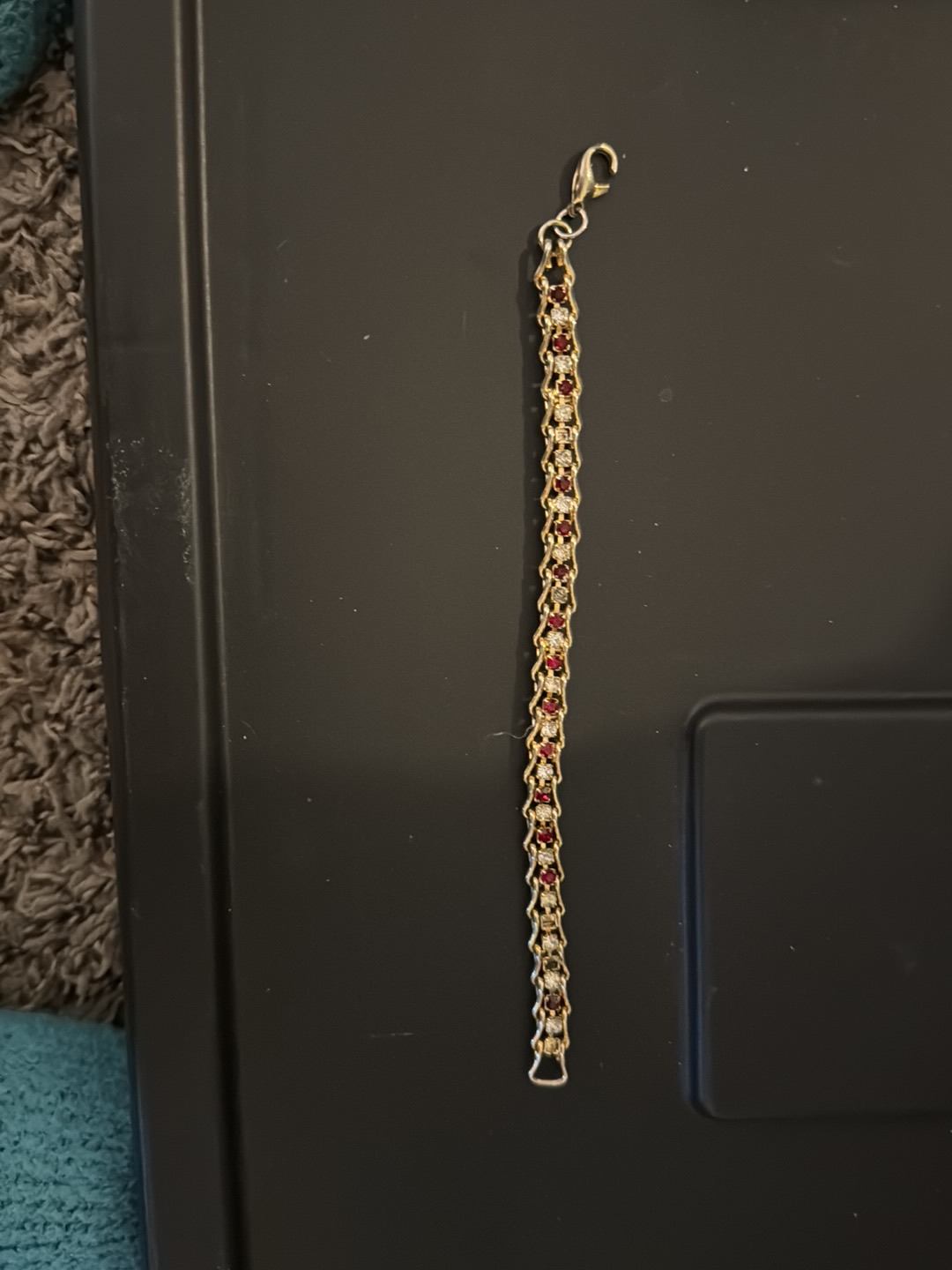 Gold-tone bracelet with red and clear crystals