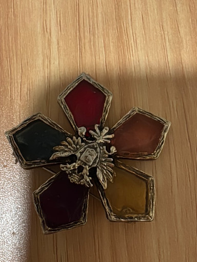 Vintage costume jewelry brooch titled 'Venetian Glow Star' by Coro