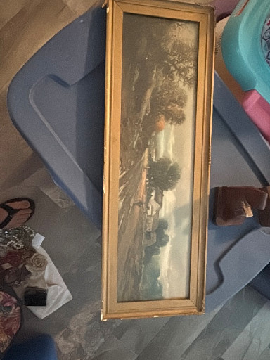 Framed landscape print depicting a pastoral scene with trees and water