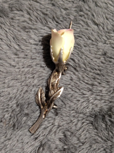 Sterling silver rose brooch with cream or amber-colored enamel bud