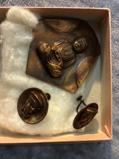 Copper jewelry set featuring Buddha pendant, brooch, and cufflinks