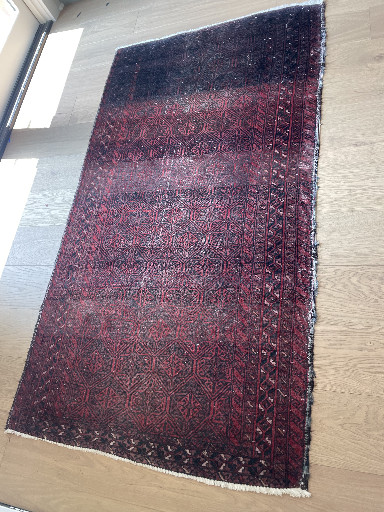 Hand-knotted wool rug titled 'Baluchistan Red' from Baluchistan region