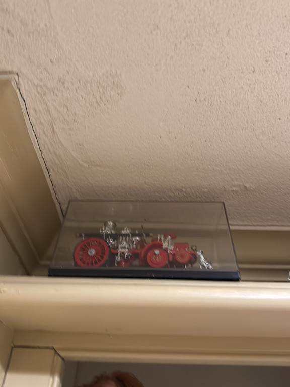 Die-cast metal model of 1912 Christie Front Drive Steamer fire engine with display case