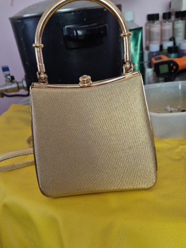 Vintage gold metallic evening handbag with structured frame and metal handle