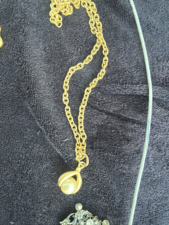 Gold-tone chain necklace with simulated pearl pendant in claw setting