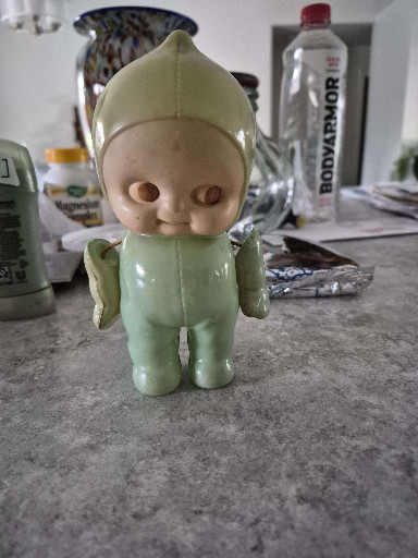Vintage celluloid Kewpie doll in green bunny suit, circa 1950s-1960s