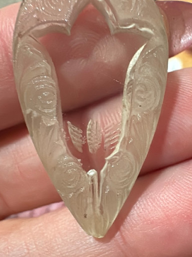 Carved jade pendant depicting a phoenix or bird motif