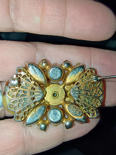 Vintage goldtone metal brooch with turquoise enamel and faux pearl accents in floral design