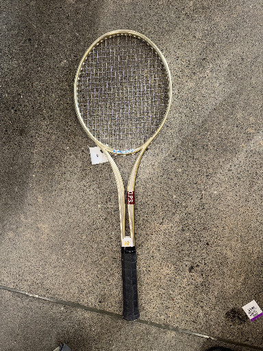 Vintage wooden tennis racquet with black grip