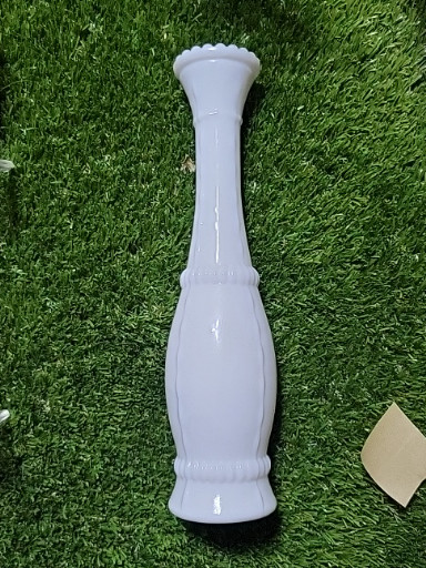 Milk glass bud vase with beaded stitching pattern