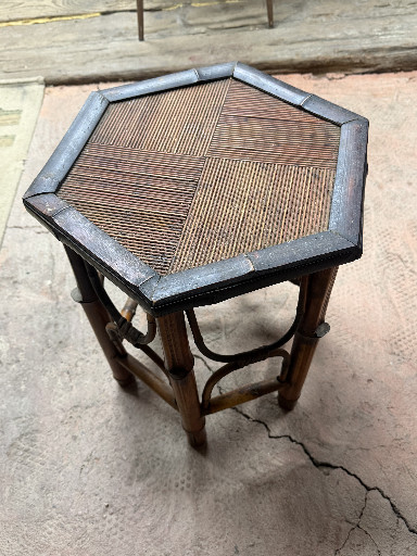 Vintage hexagonal rattan side table with woven cane top and dark wood frame