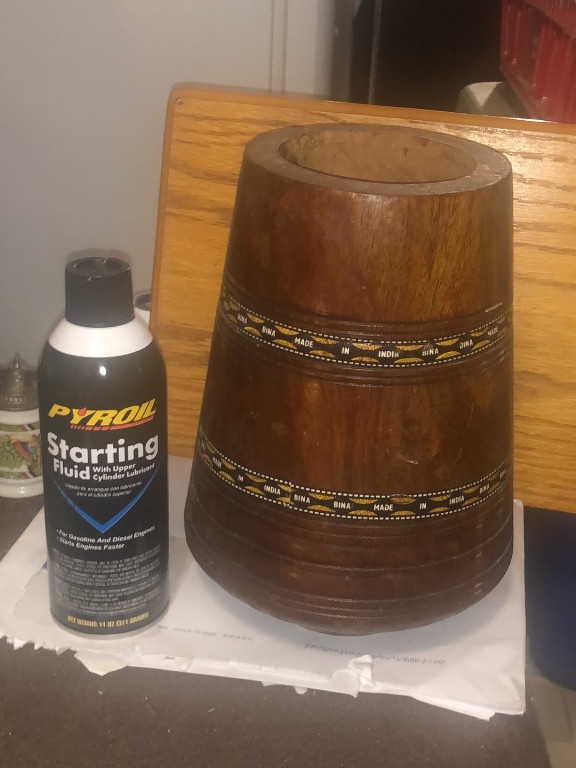 Wooden barrel-shaped vessel with brass bands marked 'Bina India'